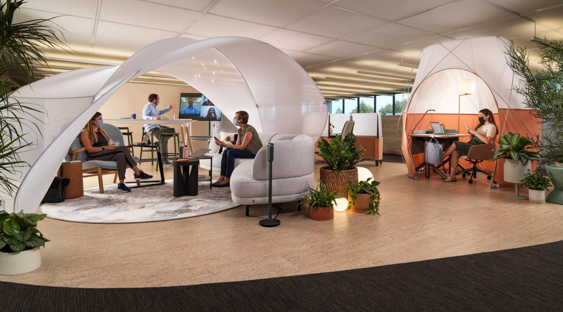 Creative collaboration area with open seating in corporate environment